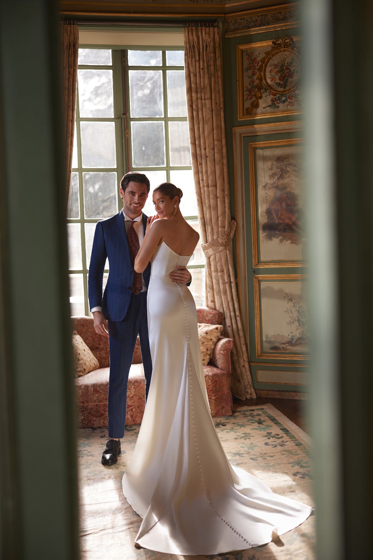 Robe de mariée sirène Sodden, avec un décolleté bustier souplement drapé et une fente haute en satin fluide.