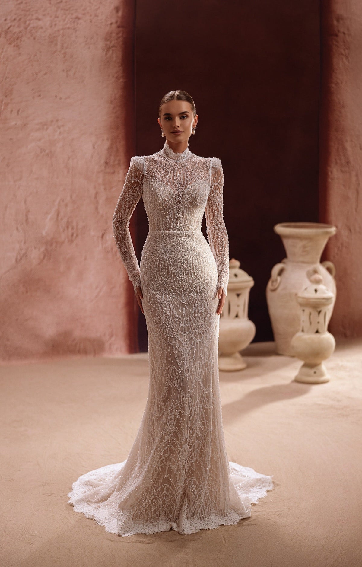 Robe de mariée Henriette, avec un corsage en dentelle à col montant, de longues manches et des perles délicates.