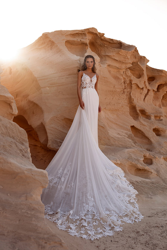 Cape de mariée Malika, avec une longue traîne cathédrale et des appliqués de dentelle florale.